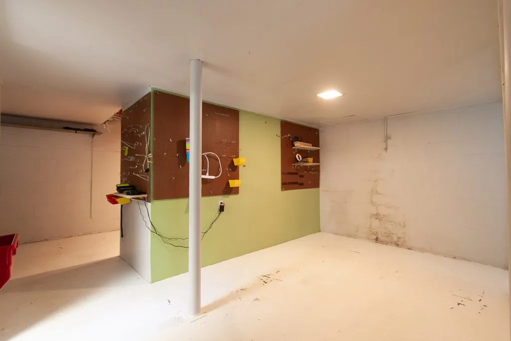 This spacious basement offers a functional workspace and ample storage.