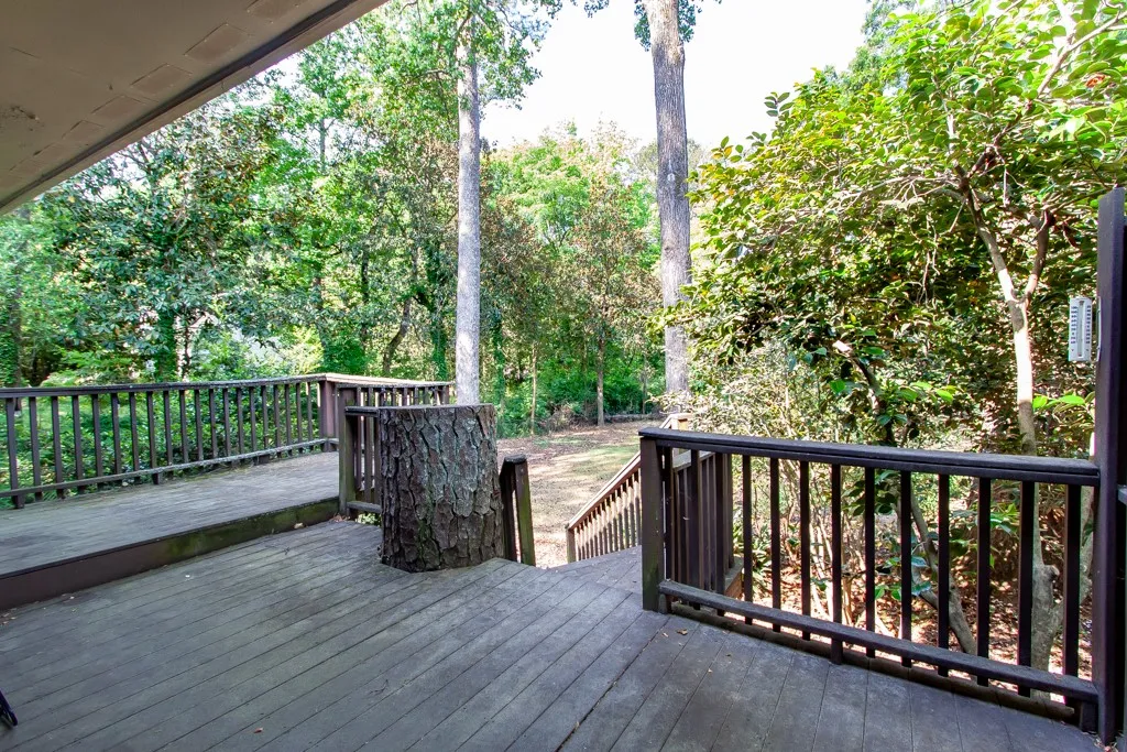 Enjoy nature's embrace from this expansive outdoor deck, perfect for peaceful mornings or serene evenings.
