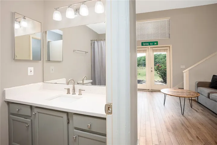 This bright bathroom features a spacious vanity, offering a pristine and functional space for daily routines.