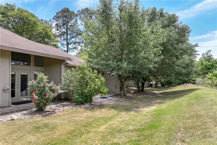 This residence features a well-maintained exterior, mature trees, and a vibrant garden.
