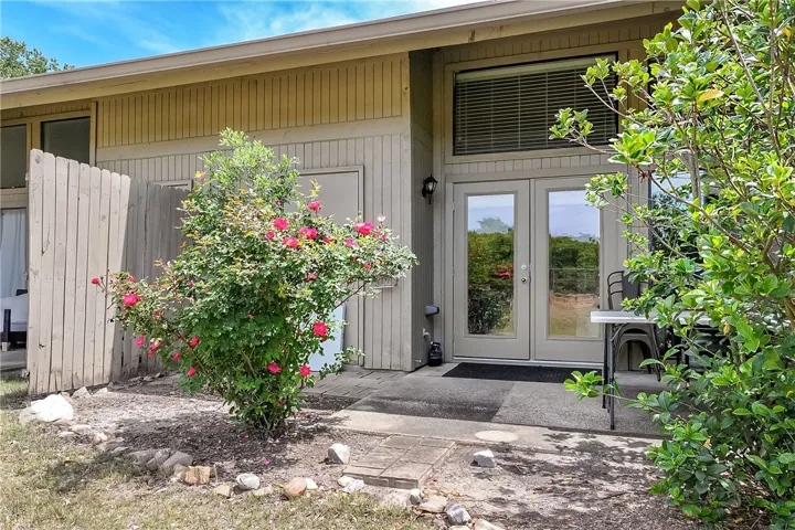 This inviting home offers an accessible private entrance with lush landscaping.