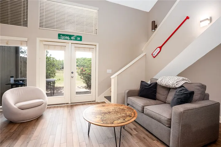 This inviting living area boasts rich Luxury Vinyl flooring and convenient outdoor access.