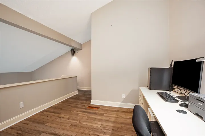 This versatile loft area features durable LVP flooring, offering an ideal space for work or relaxation, or possibly another bed.