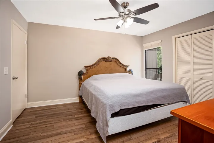 This spacious room features rich LVP flooring, a window providing natural light, and a convenient closet.