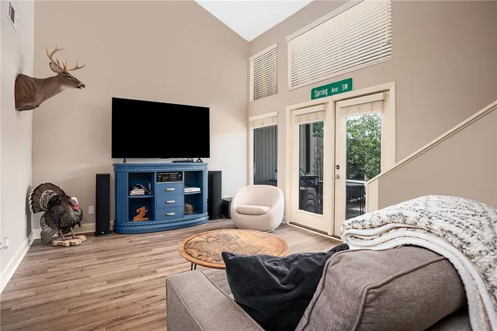 This airy living area features vaulted ceilings and direct access to an outdoor space.