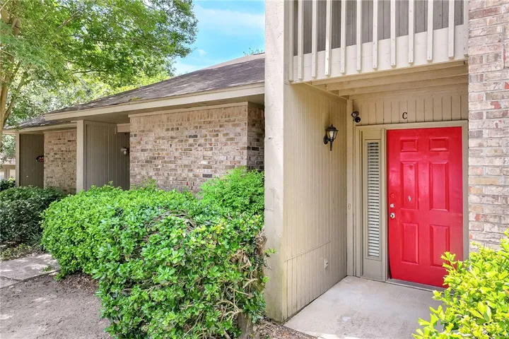 Welcome to a charming residence featuring classic brick construction and lush greenery, enhancing its inviting curb appeal.