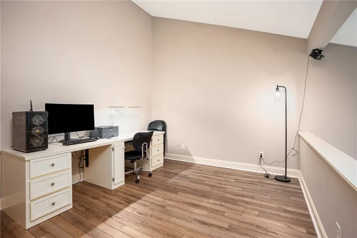 This versatile loft area features durable LVP flooring, offering an ideal space for work or relaxation, or possibly another bed.