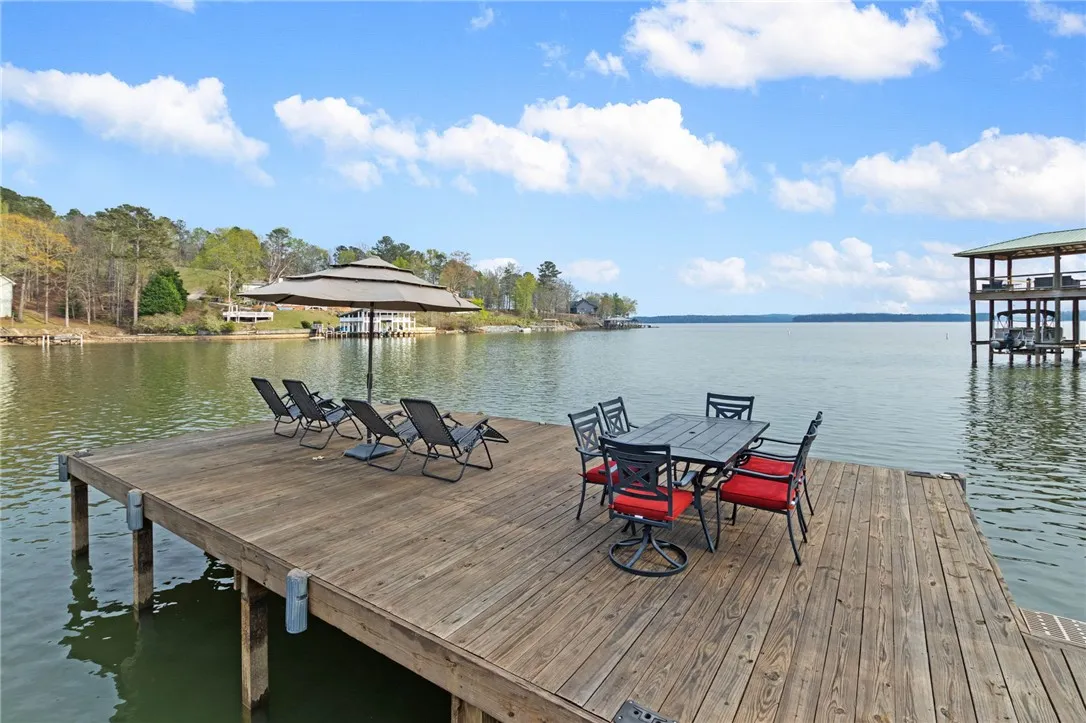 This expansive wooden dock offers a perfect setting for waterside relaxation and entertainment.