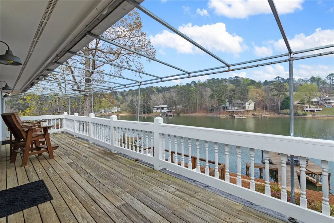 An inviting deck extends over the serene lake, perfect for outdoor relaxation.
