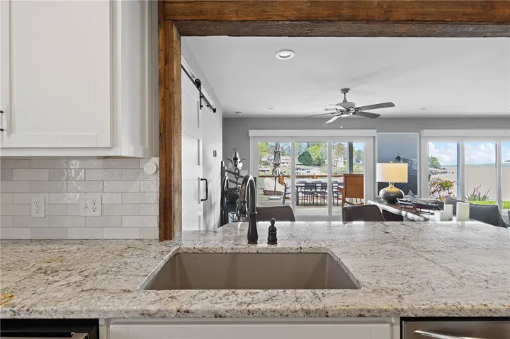 This modern kitchen features elegant countertops and seamless indoor-outdoor living.