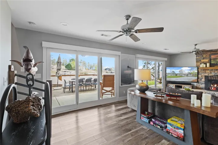 This inviting living space features expansive glass doors, opening to an outdoor deck perfect for relaxation.