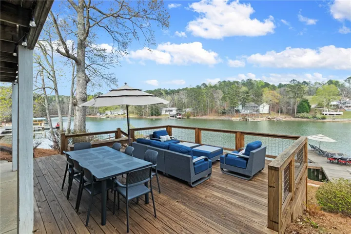 This spacious deck offers serene waterfront views, perfect for outdoor enjoyment and entertaining.