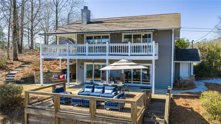 This two-story home features a spacious balcony and deck, perfect for outdoor living and entertaining.