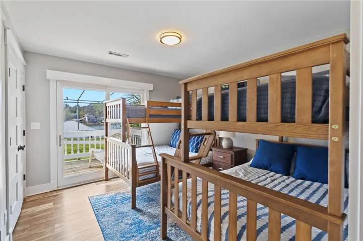 This spacious bedroom offers comfortable accommodations and direct access to an outdoor deck.