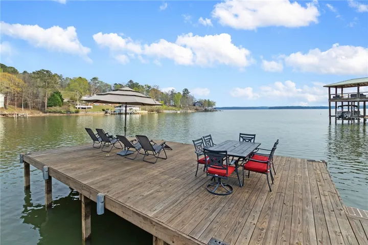 This expansive wooden dock offers a perfect setting for waterside relaxation and entertainment.