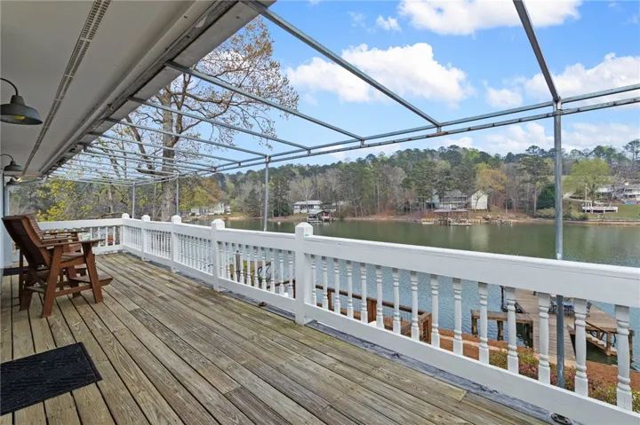 An inviting deck extends over the serene lake, perfect for outdoor relaxation.
