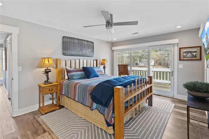 This tranquil bedroom offers a private retreat with immediate access to outdoor living.