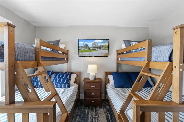 This cozy bedroom features multiple bunks, offering comfortable accommodations for all.