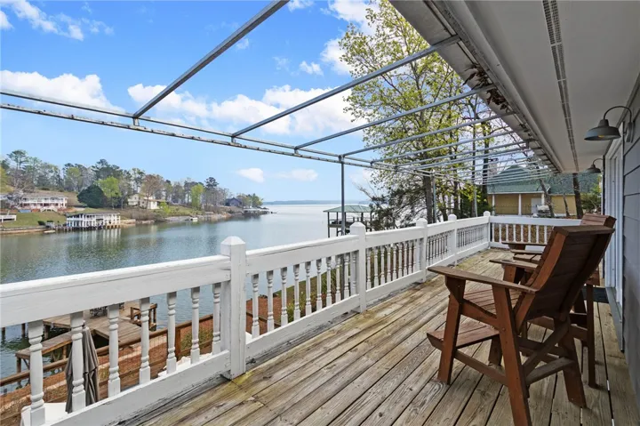 This inviting patio with a pergola offers direct water views and serene outdoor living.