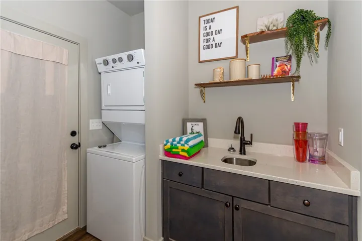 Functional laundry space featuring modern appliances and practical counter space for everyday tasks.