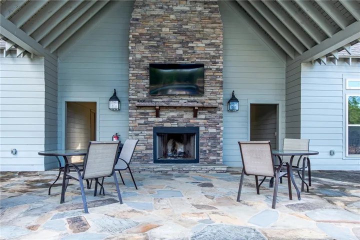 This patio features a cozy fireplace, perfect for outdoor gatherings and relaxation.