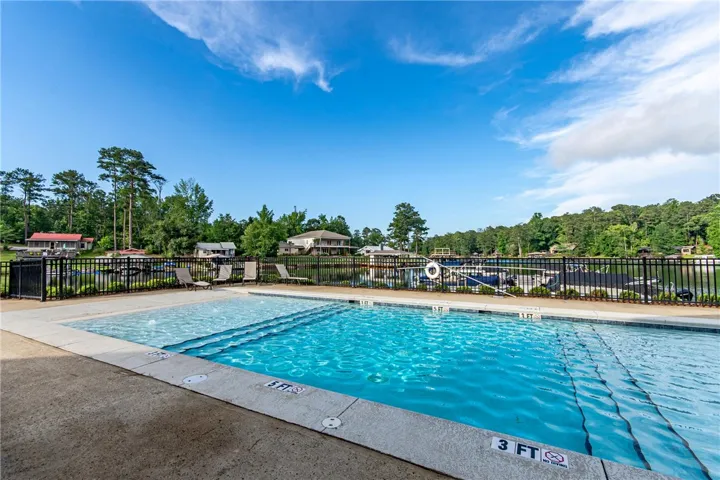 Enjoy lakeside living with a refreshing pool overlooking serene waters.