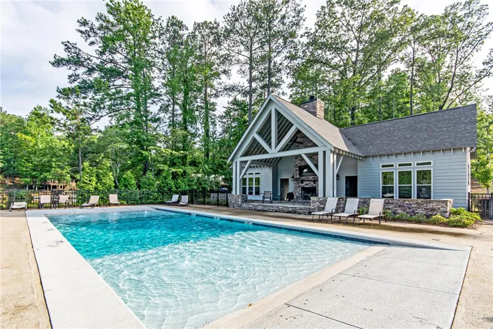 This tranquil setting features a refreshing pool alongside a charming clubhouse, offering leisure and relaxation.