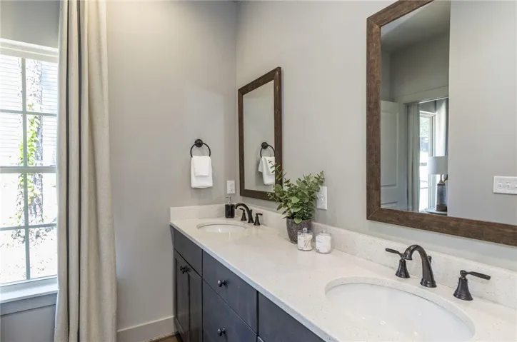 This bathroom features a double vanity with ample counter space and stylish fixtures.