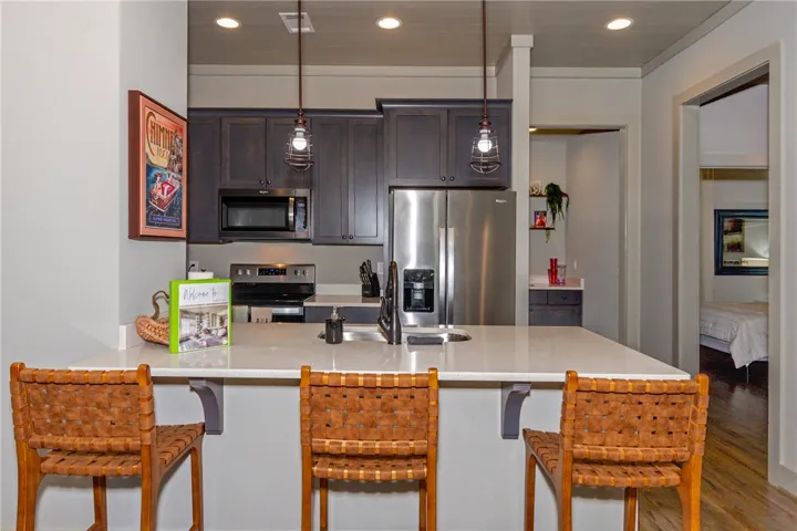 This modern kitchen features sleek countertops and appliances, ideal for culinary pursuits.