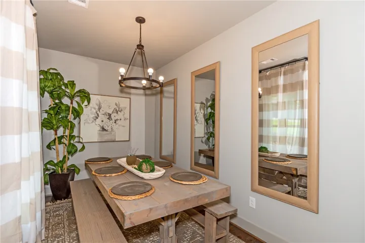 This intimate dining area features a unique wooden table, perfect for gatherings.