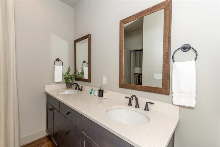 This spacious bathroom boasts a double vanity with modern fixtures and ample counter space.