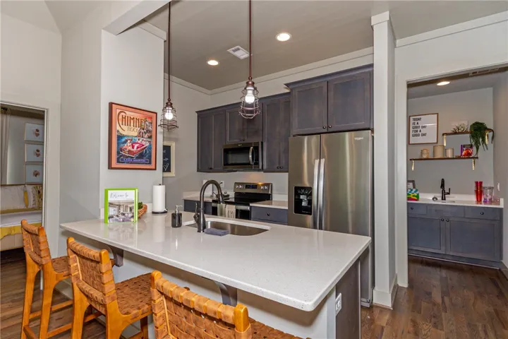 This kitchen features stainless steel appliances, ample counter space, and convenient island seating.