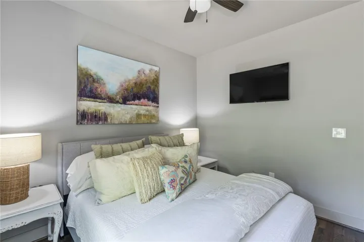This cozy bedroom offers a tranquil retreat with soft lighting and a comfortable sleeping area.