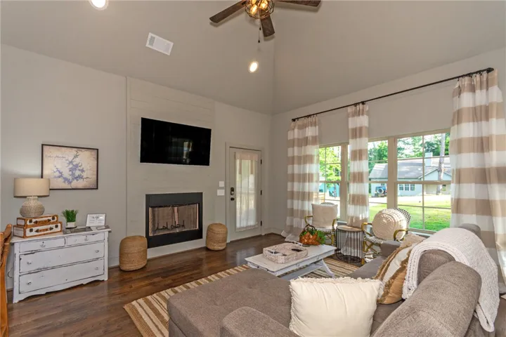 This inviting living area boasts a cozy fireplace and abundant natural light.