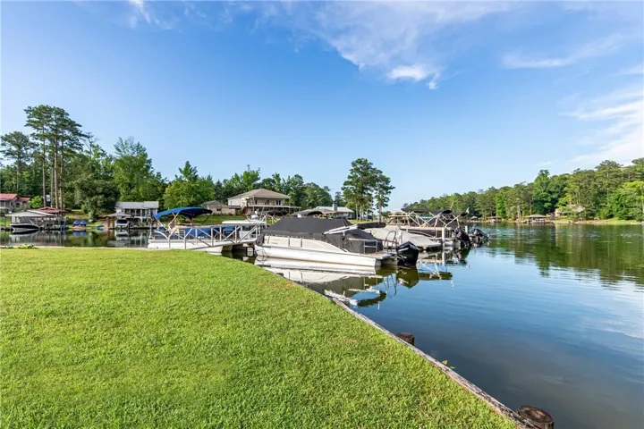 This tranquil waterfront property offers private boat docks and serene lake views, perfect for leisure.