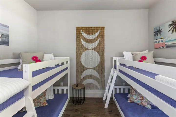 This spacious bedroom offers ample sleeping arrangements for guests.