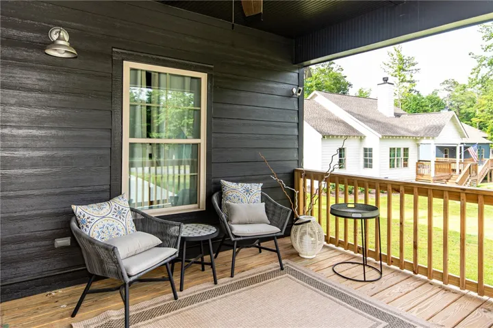 This inviting porch offers a tranquil retreat with ample space for relaxation and enjoyment.