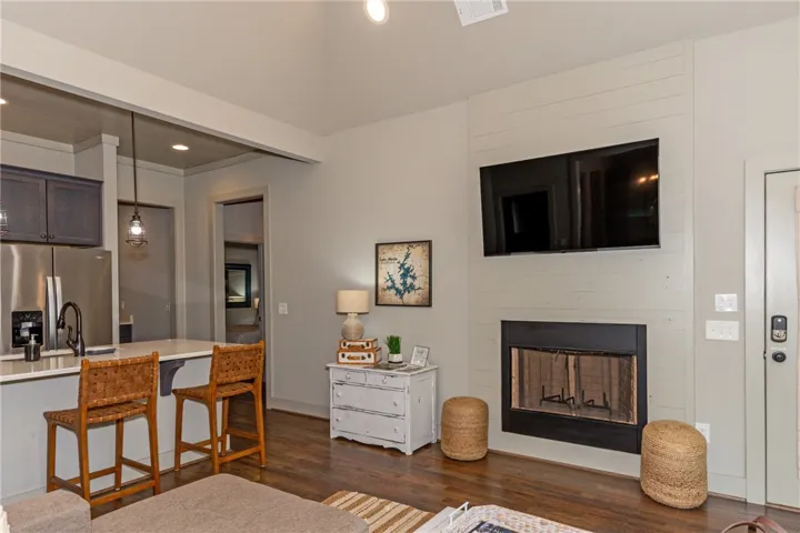 This inviting space features a welcoming fireplace and convenient kitchen access.