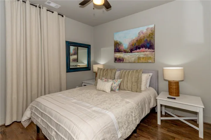 This tranquil sleeping space features warm wood floors and abundant natural light.