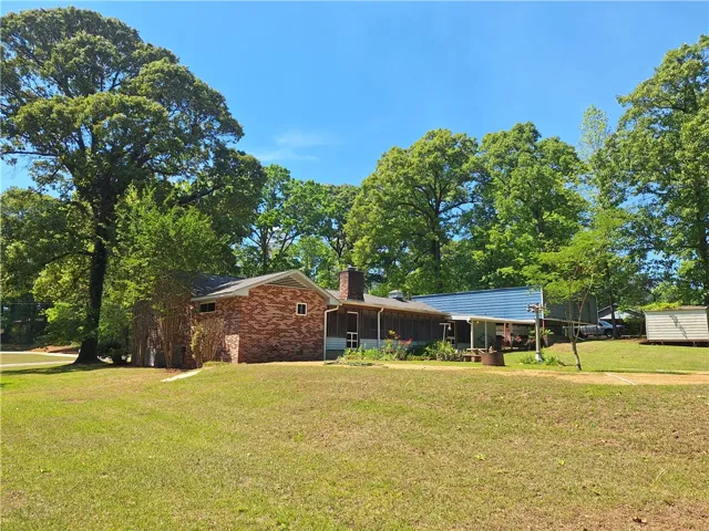 This charming residence is nestled amidst lush greenery, offering a private yard and serene outdoor living.