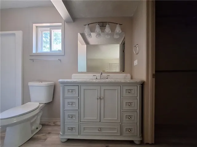This bathroom features a contemporary vanity and ample natural light.