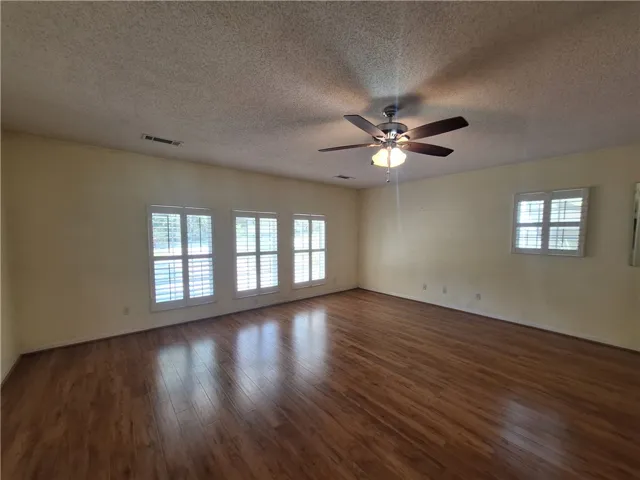 This expansive room offers abundant natural light and versatile living space.