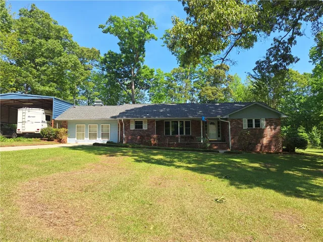 This charming home offers a tranquil retreat with a spacious yard and classic brick exterior.
