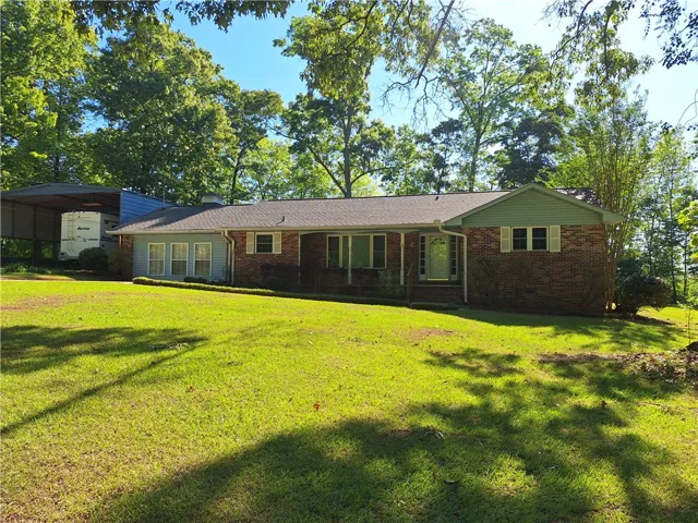 This charming home offers a serene escape with its lush, expansive yard and mature trees.