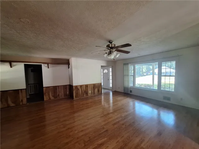 This expansive living area features lustrous hardwood floors and abundant natural light.