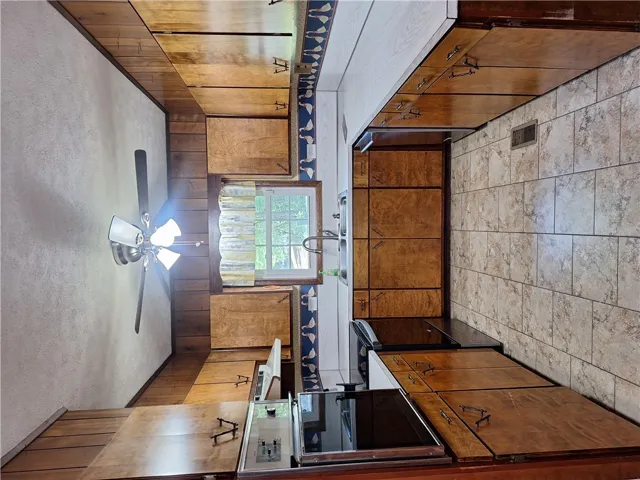 This spacious kitchen features ample cabinetry and a functional layout, ideal for culinary endeavors.