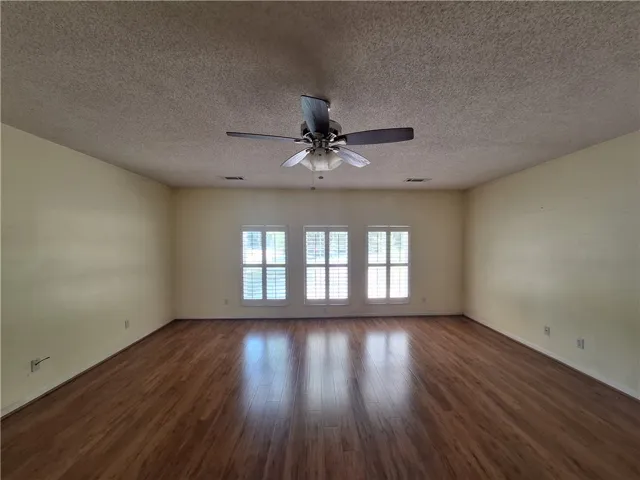 This expansive room offers abundant natural light and durable flooring, ideal for various living arrangements.