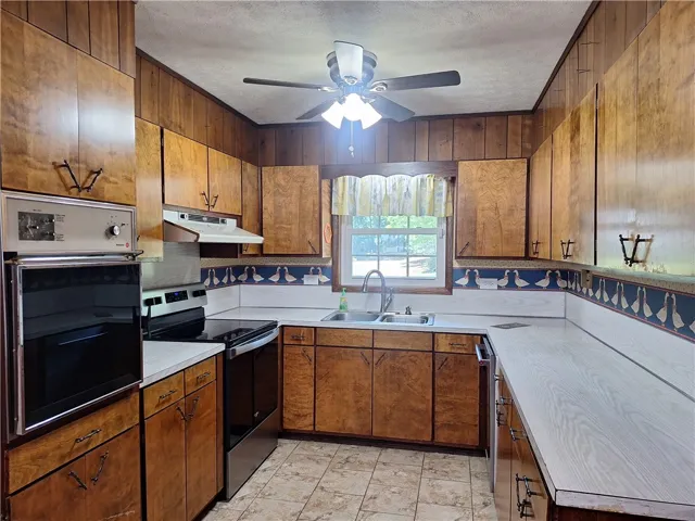 This spacious kitchen offers ample cabinet and counter space, ideal for culinary pursuits.