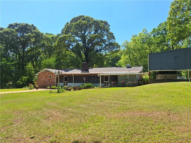 This charming home features a lovely screened porch and a detached carport.