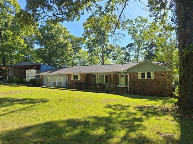 This charming home features a classic brick exterior, inviting you into a peaceful retreat.